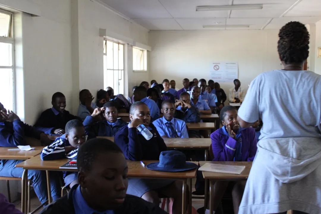 Students listening attentively during a school outreach program
